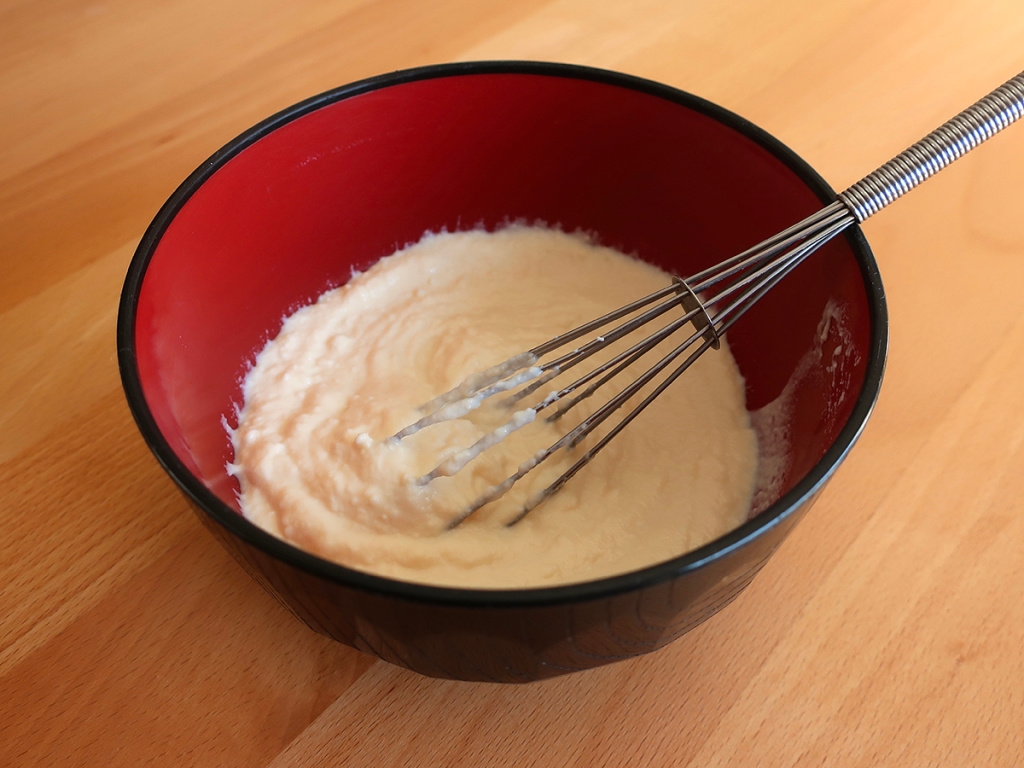 Silken tofu whisked in a bowl for dressing